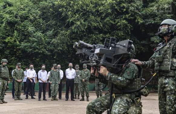 In this photo released by the Taiwan Ministry of National Defense, Taiwan&#039;s President Tsai Ing-wen watches soldiers operate equipment during a visit to a naval station on Penghu, an archipelago o ...