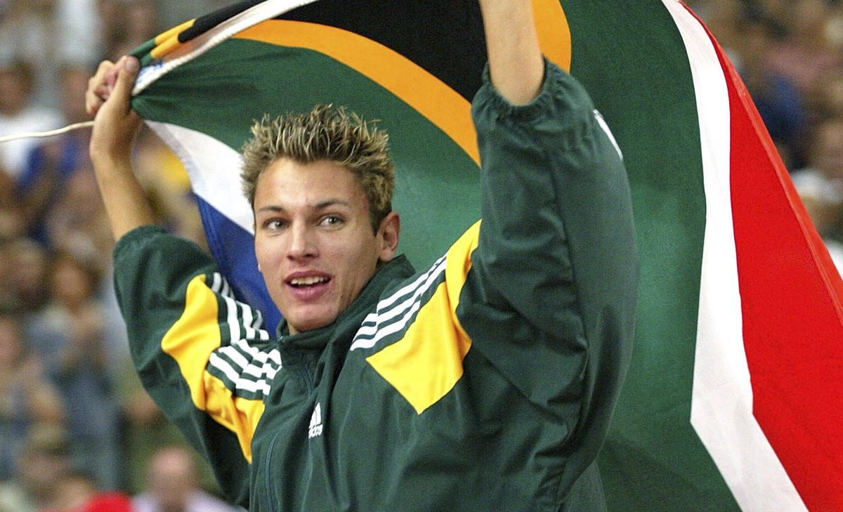 FILE - Jacques Freitag of South Africa waves his national flag after he won the Men's high jump event at the World Athletics Championships, at the Stade de France in Saint Denis, north of Paris,  ...