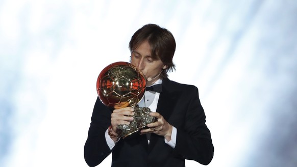 Real Madrid's Luka Modric celebrates with the Ballon d'Or award during the Golden Ball award ceremony at the Grand Palais in Paris, France, Monday, Dec. 3, 2018. Awarded every year by France ...