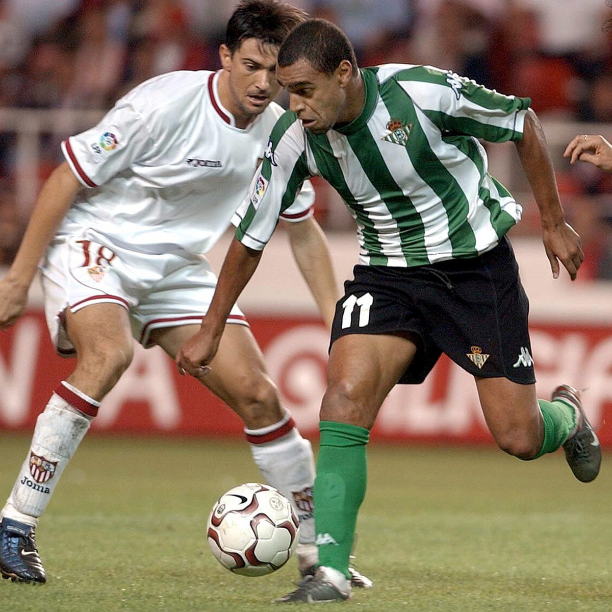 Real Betis' Brazilian player Denilson, center, dribbles the ball between Seville's Pabro Alfaro, right, and Marti in a Spanish league soccer match in Seville, Spain Sunday Oct. 19, 2003. (AP ...