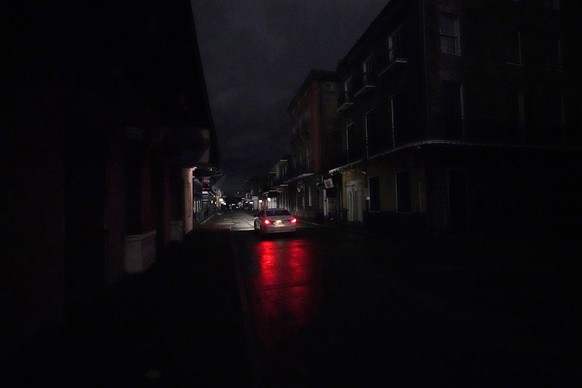 A passing car&#039;s headlights illuminate a darkened Bourbon Street in the French Quarter of New Orleans, Wednesday, Oct. 28, 2020. Hurricane Zeta passed through today leaving much of the city and me ...