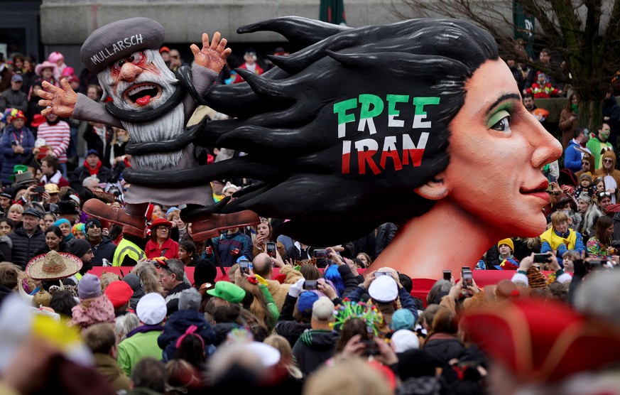 epa10479920 A carnival float depicting an Iranian man entangled in a woman?s hair parades during the annual Rose Monday (Rosenmontag) parade in Duesseldorf, Germany, 20 February 2023. Rose Monday is t ...