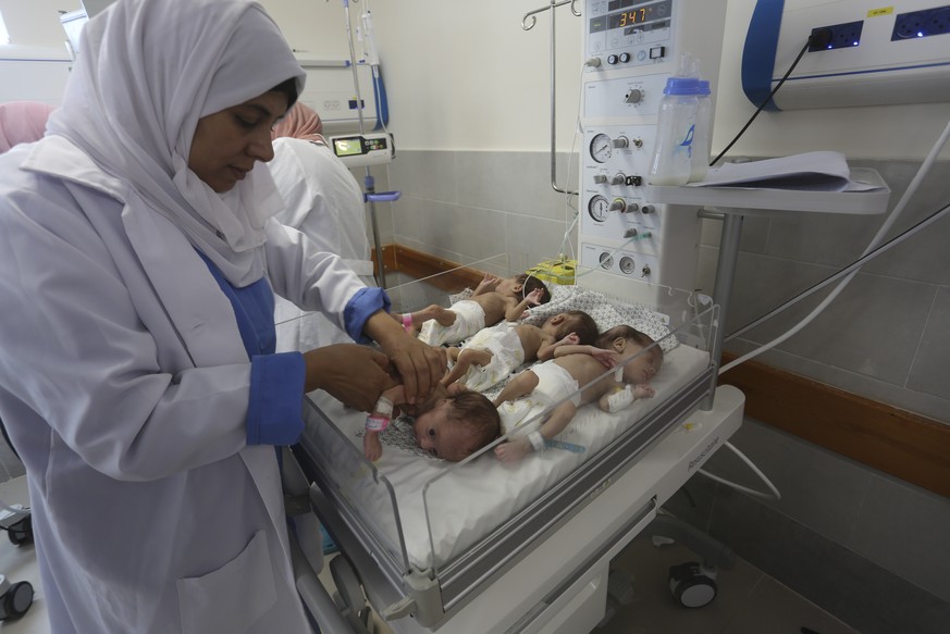 Medical staff care for premature Palestinian babies who were taken from Shifa Hospital in Gaza City to the hospital in Rafah, Gaza Strip, on Sunday, November 19, 2023.  (AP Photo/Hatem Ali)
