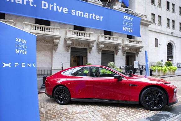 In this photo provided by the New York Stock Exchange, a model P7 from Chinese electric carmaker XPeng, is displayed outside the NYSE, to celebrate the company&#039;s IPO, Thursday, Aug. 27, 2020, in  ...