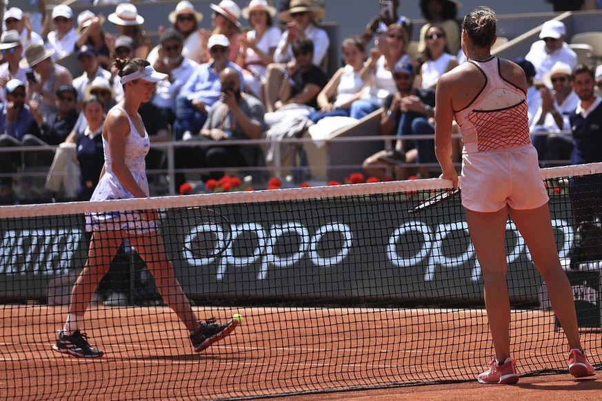 Aryna Sabalenka of Belarus, right, waits on the net as Ukraine&#039;s Elina Svitolina, left, walks off the court without shaking hands with her opponent at the end of their quarter final match of the  ...