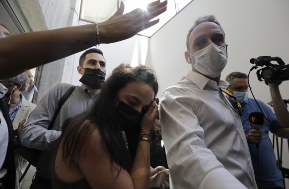 Gali Peleg, center, maternal aunt of Eitan Biran, who survived a cable car crash in Italy that killed his immediate family, leaves court in Tel Aviv on Thursday, Sept. 23, 2021 after a hearing in the  ...