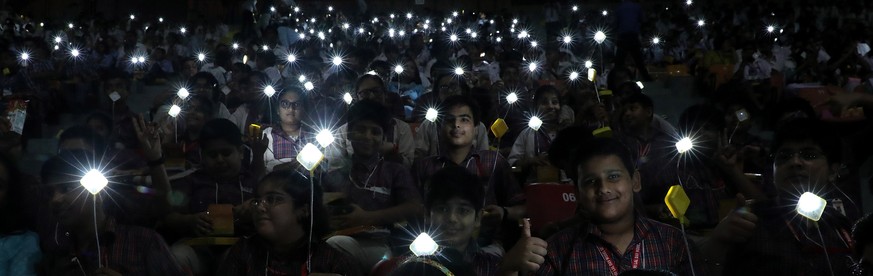 epaselect epa07889016 Indian school students hold solar lamps as they take part in the Global Student Solar Assembly to commemorate 150th birth anniversary of Mahatma Gandhi in New Delhi, India, 10 Oc ...