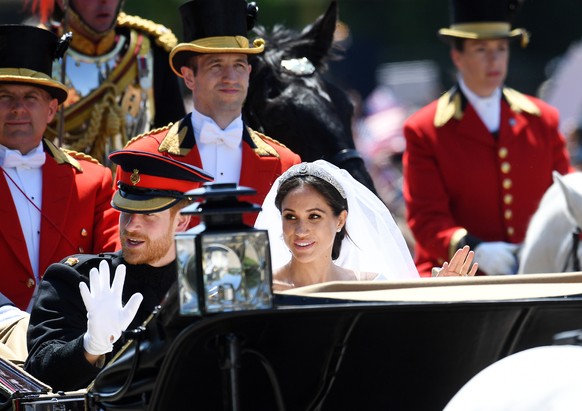 epa06749395 Britain&#039;s Prince Harry, Duke of Sussex and his wife Meghan, Duchess of Sussex ride in a horse-drawn Ascot Landau carriagealong The Long Walk towards Windsor Castle during a procession ...