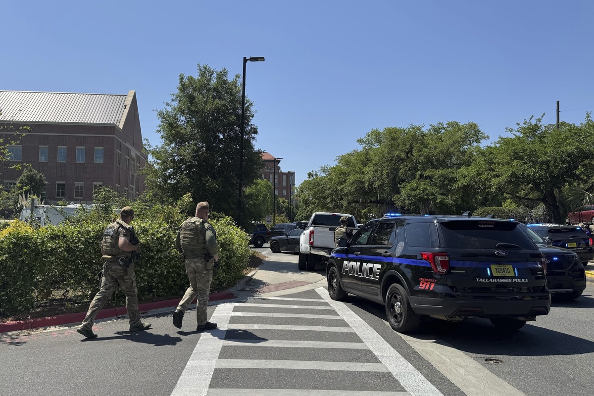 Dozens of patrol vehicles, including a forensics van, are stationed outside of Florida State University?s student union building, the scene of a shooting, Thursday, April 17, 2025, in Tallahassee, Fla ...