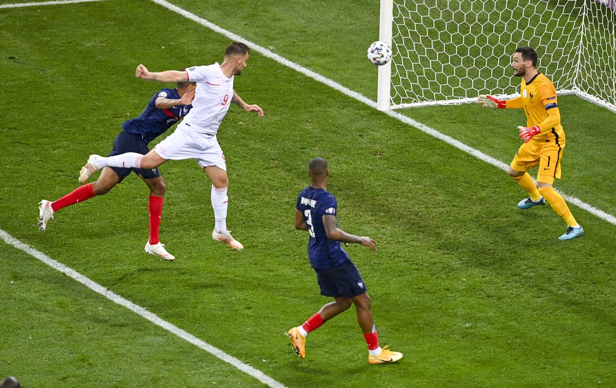 Switzerland's Haris Seferovic, second left, scores his team's second goal during the Euro 2020 soccer championship round of 16 match between France and Switzerland at National Arena stadium, ...