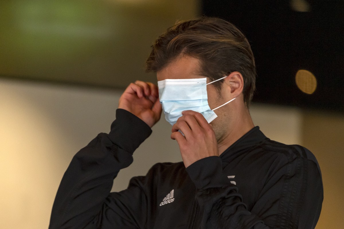 epa08584952 Basel's captain Valentin Stocker jokes while putting on his face mask after a press conference at the St. Jakob-Park stadium in Basel, Switzerland, 05 August 2020. Switzerland's  ...