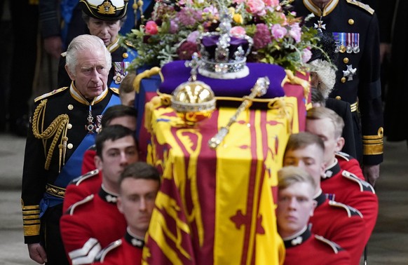 King Charles III and members of the Royal family follow behind the coffin of Queen Elizabeth II, draped in the Royal Standard with the Imperial State Crown and the Sovereign&#039;s orb and sceptre, as ...