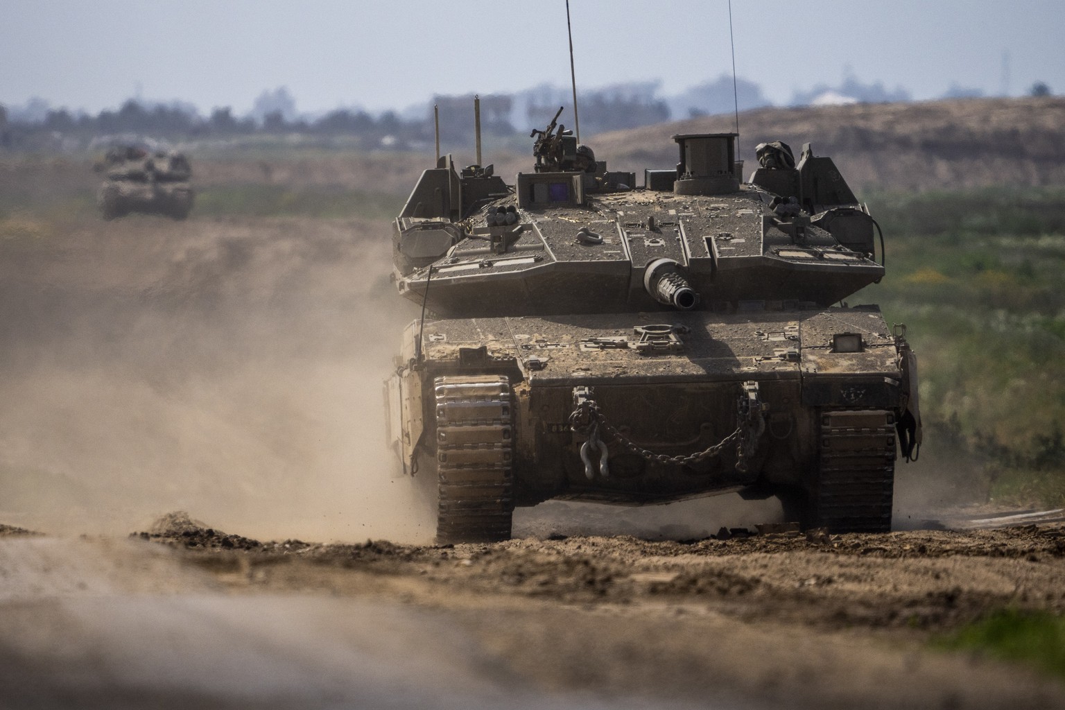 Israeli soldiers drive a tank on the border with Gaza Strip, in southern Israel, Tuesday, March 19, 2024. The army is battling Palestinian militants across Gaza in the war ignited by Hamas&#039; Oct.  ...