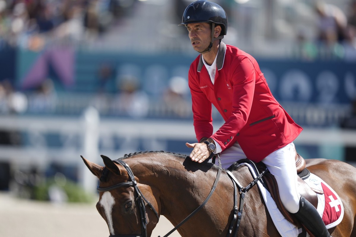 Switzerland's Steve Guerdat, riding Dynamix De Belheme, during the Equestrian Jumping qualifiers, at the 2024 Summer Olympics, Monday, Aug. 5, 2024, in Versailles, France. (AP Photo/Mosa'ab  ...
