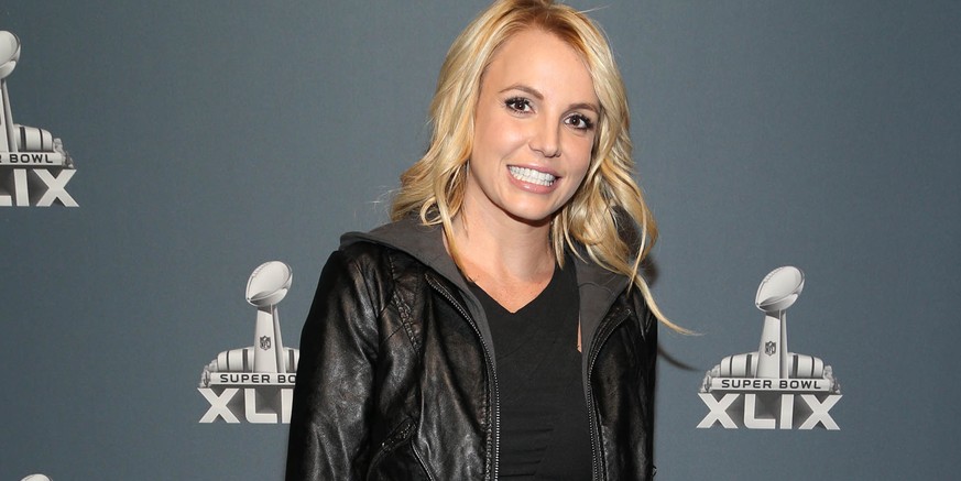 FILE - In this Feb. 1, 2015 file photo, Britney Spears arrives at the Super Bowl XLIX red carpet in Glendale, Ariz. An on-stage ankle injury has pop star Spears rescheduling her Friday and Saturday ni ...