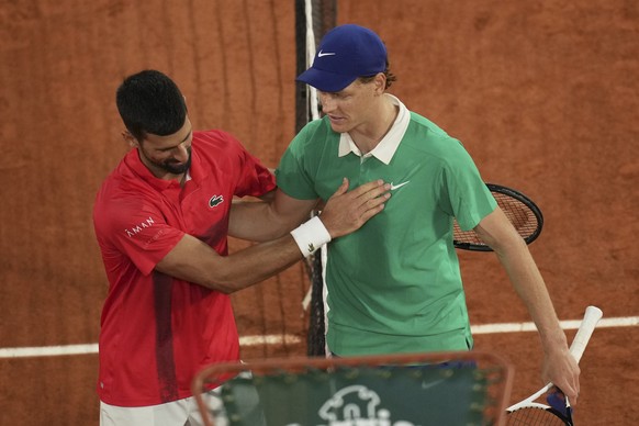 Winner Italy&#039;s Jannik Sinner, right, and Serbia&#039;s Novak Djokovic greet each other after their semifinal match of the French Tennis Open at the Roland-Garros stadium in Paris, Friday, June 6, ...