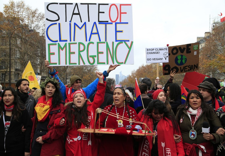 FILE - In this Saturday, Dec. 12, 2015, file photo, climate activists demonstrate during COP21, the United Nations Climate Change Conference, in Paris, France. Greenhouse gases more powerful than carb ...