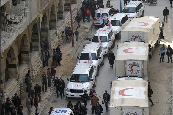 epa06583072 A handout photo made available by the Syrian Arab Red Crescent (@SYRedCrescent) shows aid convoy with medical supplies for people in Douma, eastern Ghouta, Syria, 05 March 2018. According  ...