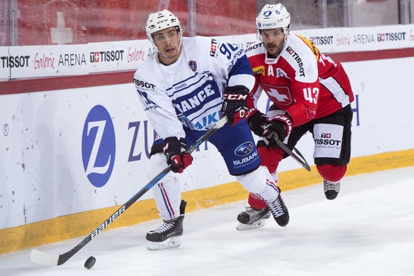 France&#039;s Maxime Moisand, left, fights for the puck with Switzerland&#039;s Morris Trachsler, right, during the Swiss Ice Hockey Challenge 2016 between Switzerland and France, at the Tissot Arena  ...