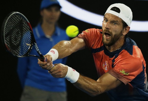 Austria&#039;s Jurgen Melzer makes a backhand return to Switzerland&#039;s Roger Federer during their first round match at the Australian Open tennis championships in Melbourne, Australia, Monday, Jan ...