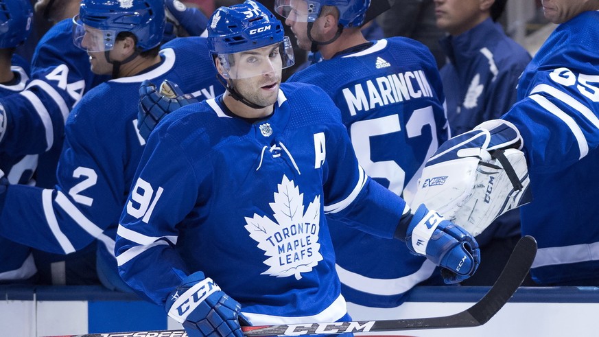 FILE - In this Friday Sept. 21, 2018 file photo, Toronto Maple Leafs&#039; John Tavares is congratulated by teammates following his goal against the Buffalo Sabres during first-period NHL hockey game  ...