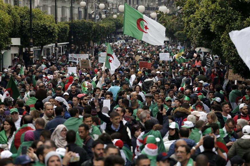 Demonstrators hold Algerian flags and chant slogans during a protest in Algiers, Algeria, Friday, May 3, 2019. Tens of thousands of Algerians protested for an 11th straight week on Friday to pressure  ...