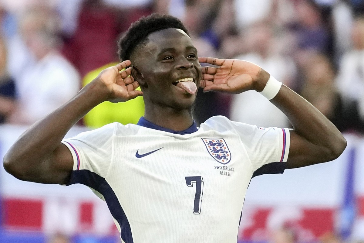 England's Bukayo Saka reacts after scoring by penalty during a quarterfinal match between England and Switzerland at the Euro 2024 soccer tournament in Duesseldorf, Germany, Saturday, July 6, 202 ...