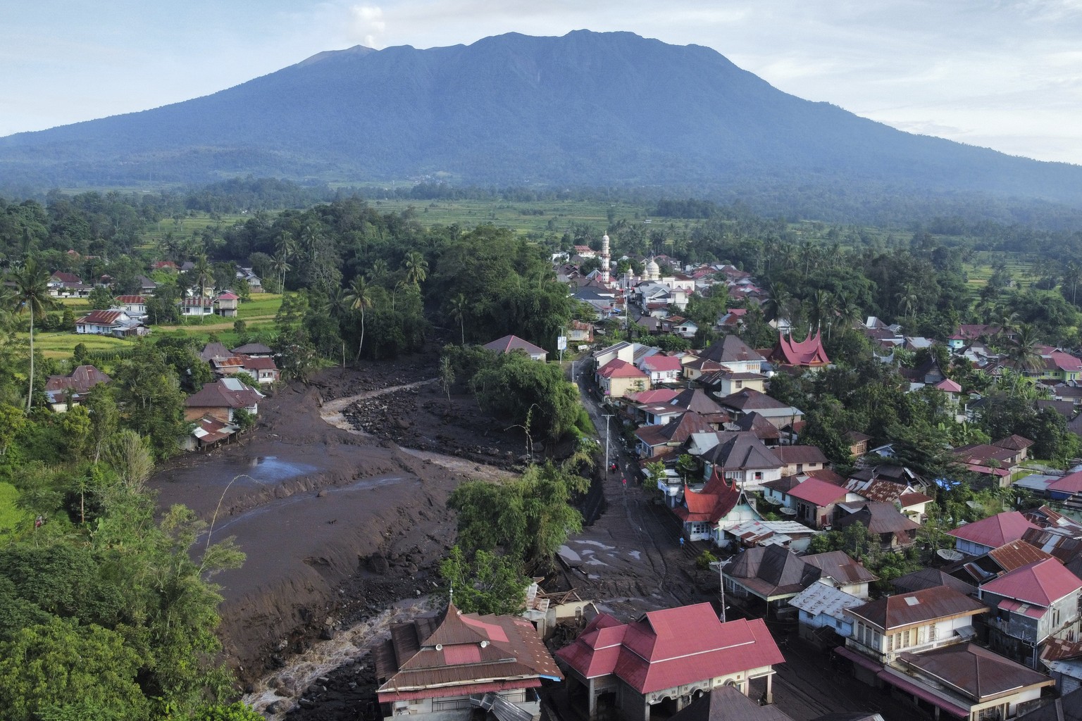 This drone photo shows the damage at a village affected by a flash flood in Tanah Datar, West Sumatra, Indonesia, Monday, May 13, 2024. Heavy rains and torrents of cold lava and mud flowing down a vol ...