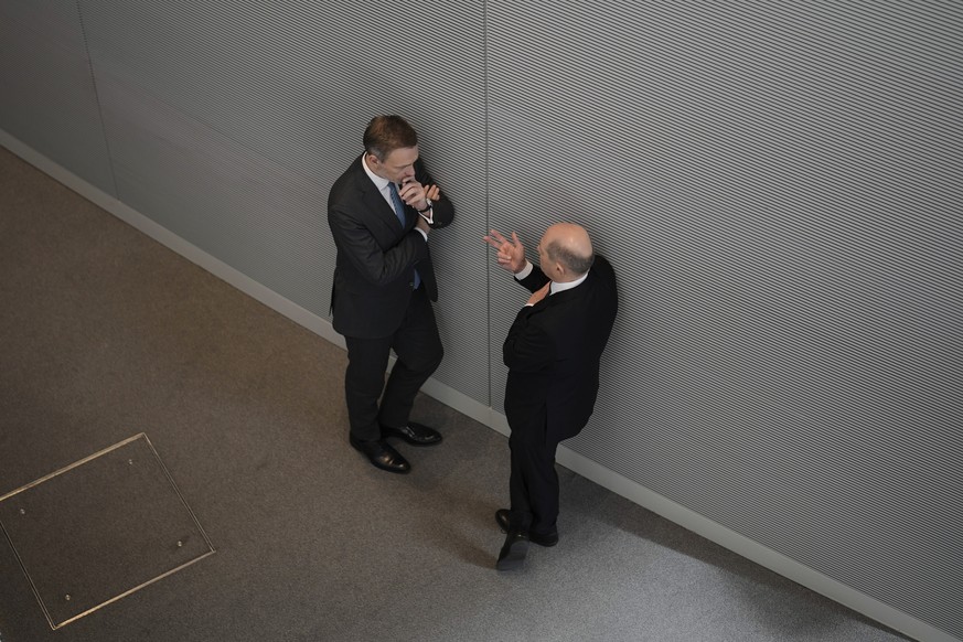 German Chancellor Olaf Scholz, right, talks to German Finance Minister Christian Lindner, left, during a debate at the German parliament Bundestag in Berlin, Germany, Wednesday, March 20, 2024, ahead  ...