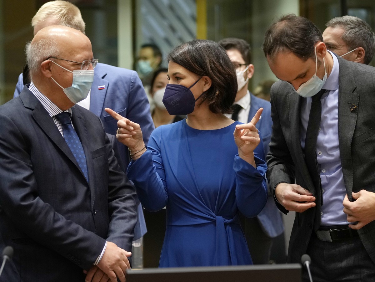 German Foreign Minister Annalena Baerbock, center, speaks with Portugal's Foreign Minister Augusto Santos Silva, left, and Slovenia's Foreign Minister Anze Logar, right, during a meeting of  ...