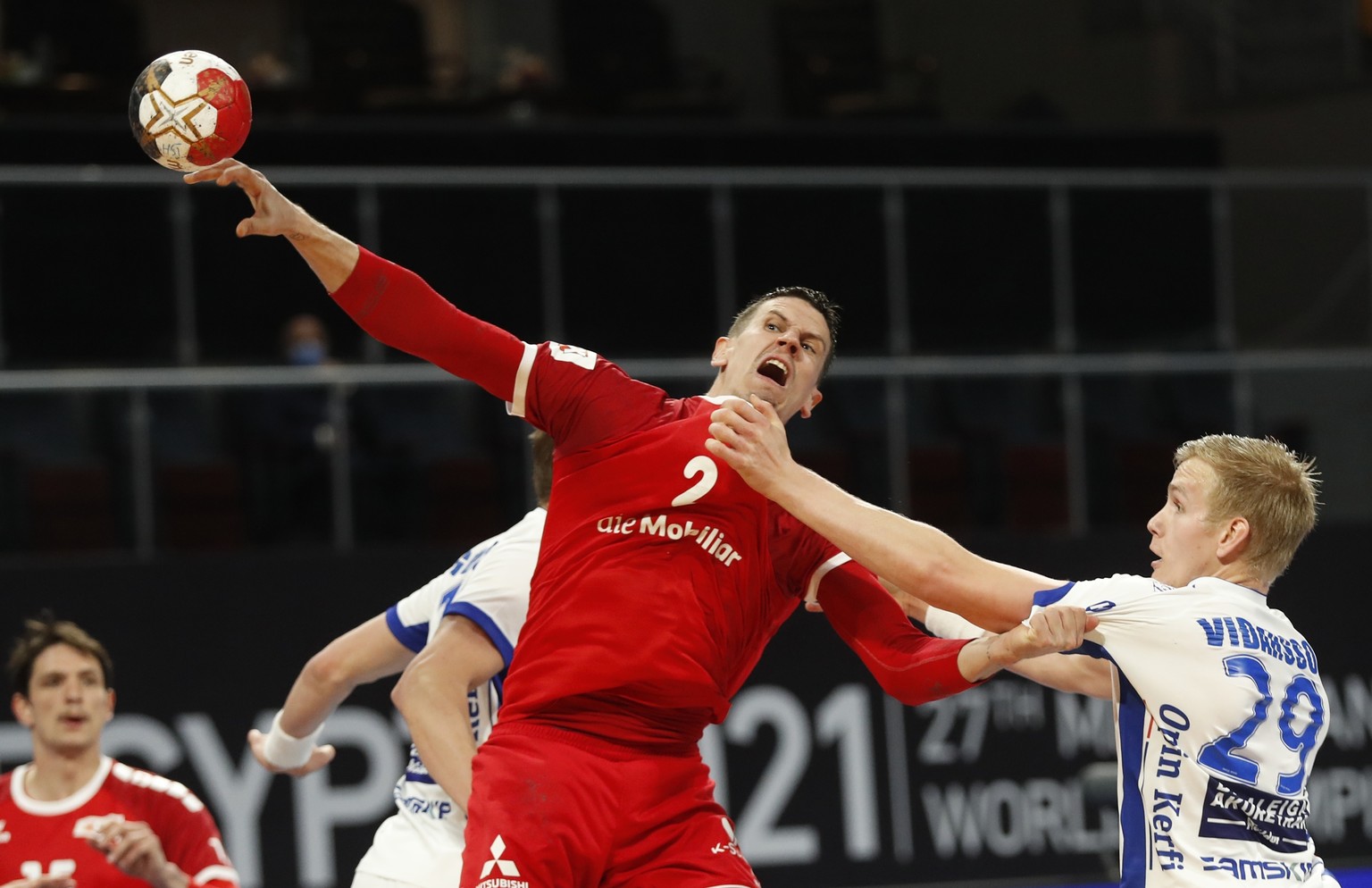 Switzerland&#039;s captain Andy Schmid throws the ball during the World Handball Championship between Switzerland and Iceland, in Cairo, Egypt, Wednesday, Jan. 20, 2021. (AP Photo/Petr David Josek, Po ...