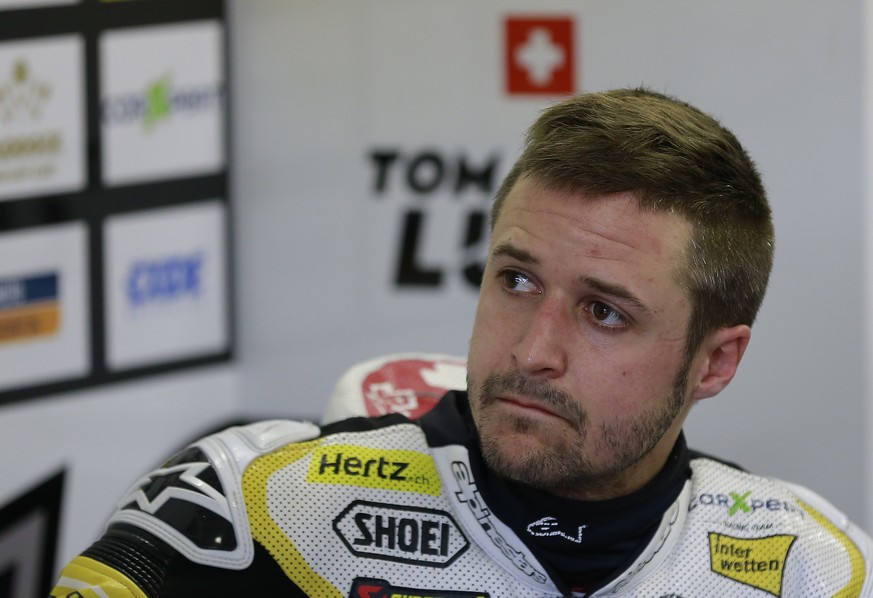 Moto2 rider Thomas Luthi of Switzerland watches a monitor during a free practice session for the MotoGP Japanese Motorcycle Grand Prix at the Twin Ring Motegi circuit in Motegi, north of Tokyo, Saturd ...