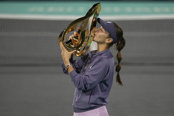 Belinda Bencic of Switzerland kisses the trophy after winning against Ashlyn Krueger of United States in the Women&#039;s single final match of the Mubadala Abu Dhabi Open tennis tournament, in Abu Dh ...