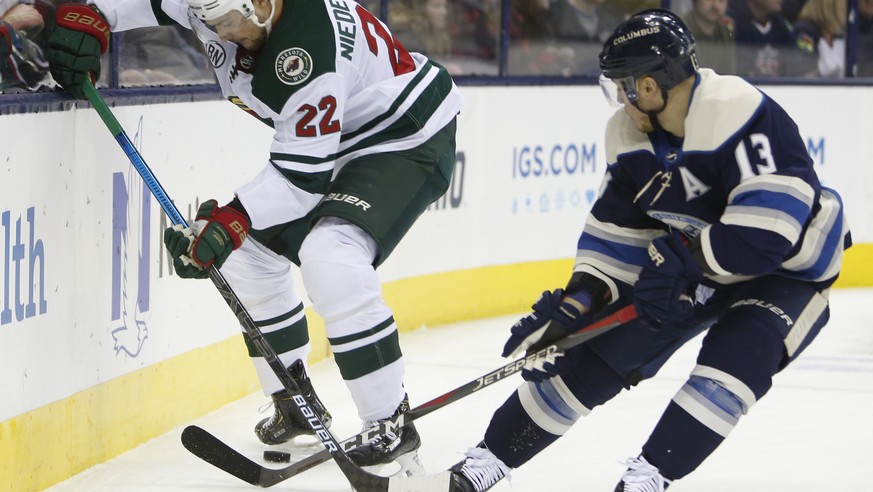 Minnesota Wild&#039;s Nino Niederreiter, left, of Switzerland, and Columbus Blue Jackets&#039; Cam Atkinson vie the the puck during the first period of an NHL hockey game Thursday, Nov. 29, 2018, in C ...