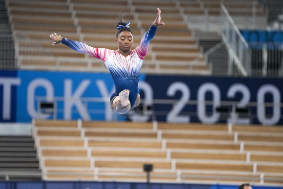 Simone Biles, of the United States, warms up prior to the artistic gymnastics balance beam final at the 2020 Summer Olympics, Tuesday, Aug. 3, 2021, in Tokyo, Japan. (AP Photo/Natacha Pisarenko)