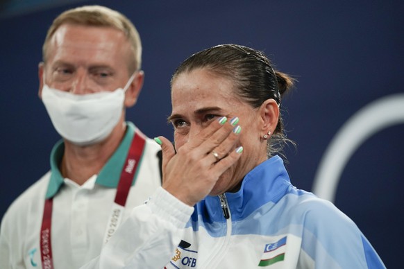 Oksana Chusovitina, of Uzbekistan, wipes away a tear after competing in vault during the women&#039;s artistic gymnastic qualifications at the 2020 Summer Olympics, Sunday, July 25, 2021, in Tokyo, Ja ...