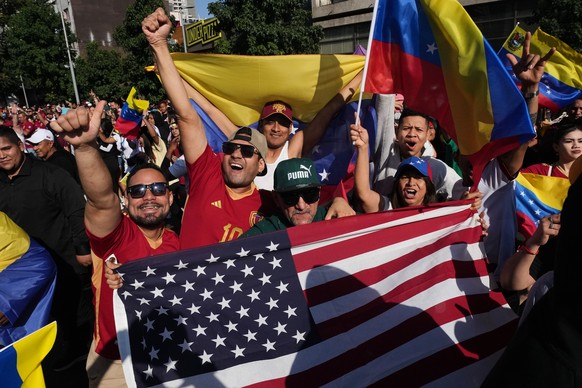 Venezuelans celebrate after U.S. President Donald Trump announced that Venezuelan President Nicolas Maduro had been captured and flown out of the country in Santiago, Chile, Saturday, Jan. 3, 2026. (A ...