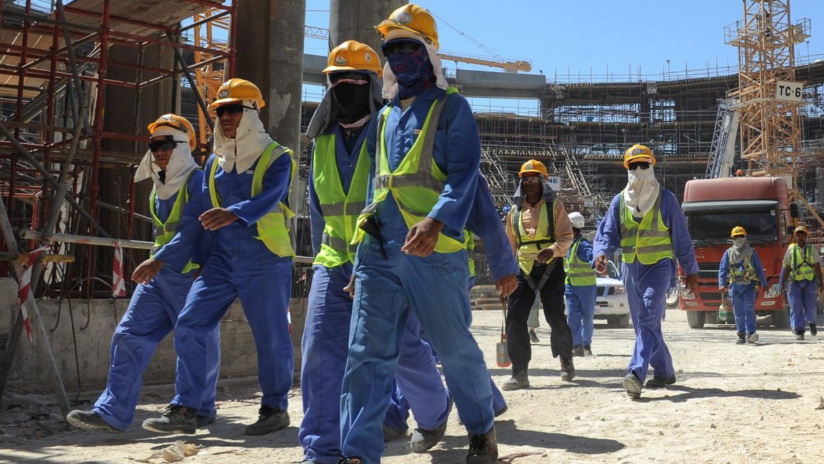 epa03956763 Foreign construction workers qleave a construction site in Doha, Qatar, 19 November 2013. The previous day, football's ruling body FIFA said it will continue to put pressure on 2022 W ...