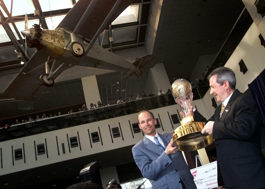 Under Lindbergh&#039;s &quot;Spirit of St. Louis,&quot; balloonists Bertrand Piccard of Switzerland, left, and Brian Jones of Great Britain, hold the Budweiser Cup, Wednesday, April 7, 1999 at the Smi ...