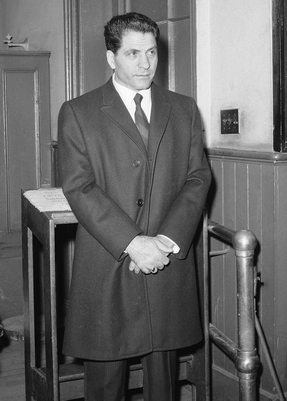 FILE - In this March 24, 1966, file photo, John "Sonny" Franzese waits to be booked at the Elizabeth Street police station in New York, after his arrest on a 43-count gambling indictment. Fr ...