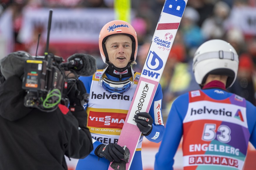 epa10371941 Dawid Kubacki (C) of Poland reacts after winning the FIS Ski Jumping World Cup in Engelberg, Switzerland, 18 December 2022. EPA/URS FLUEELER