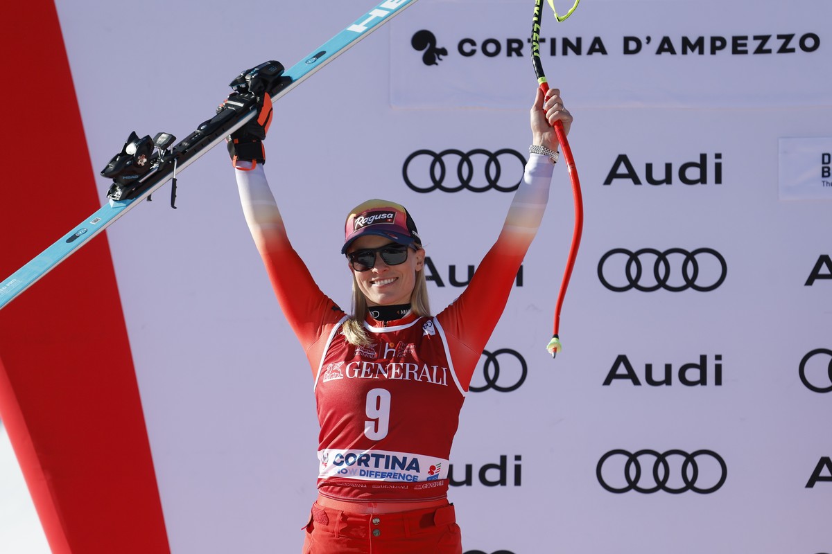 Switzerland's Lara Gut Behrami celebrates on the podium after taking second place in an alpine ski, women's World Cup downhill race, in Cortina d'Ampezzo, Italy, Friday, Jan. 26, 2024.  ...
