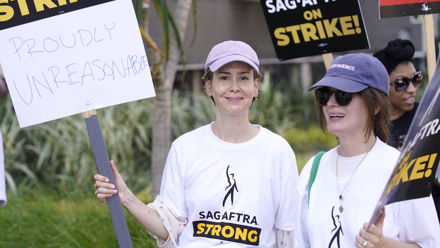 Actor Sarah Paulson, left, and Elisabeth Reaser walk on a picket line outside Netflix studios on Tuesday, July 25, 2023, in Los Angeles. The actors strike comes more than two months after screenwriter ...
