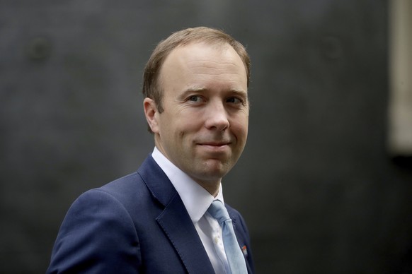 FILE - In this Wednesday, Sept. 16, 2020 file photo, British Health Secretary Matt Hancock walks from 10 Downing Street in London. BritainÄôs health minister has apologized for breaching social dista ...