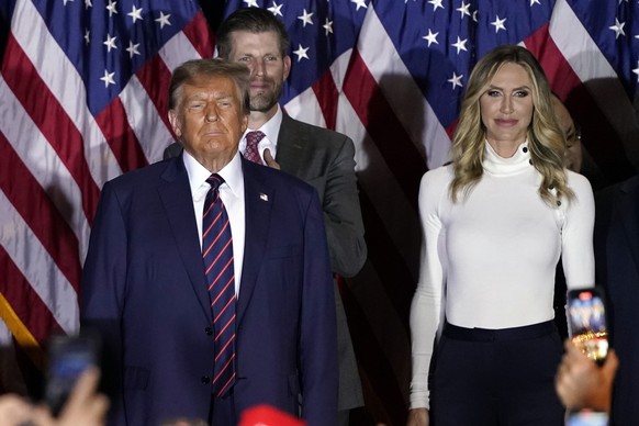 FILE - Republican presidential candidate former President Donald Trump arrives to speak at a primary election night party in Nashua, N.H., Tuesday, Jan. 23, 2024, with Eric and Lara Trump. Trump is ca ...
