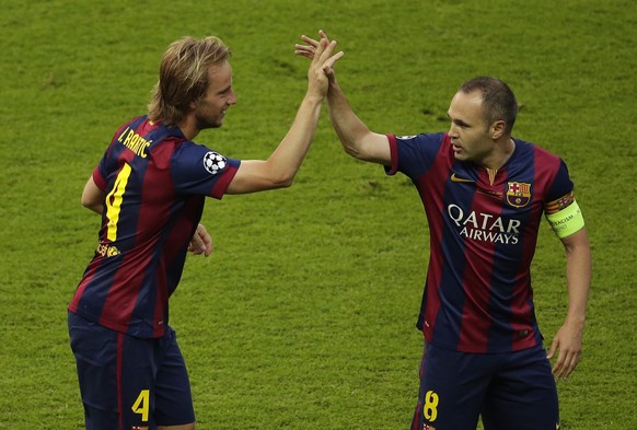 Barcelona's Ivan Rakitic, celebrates with Andres Iniesta scoring the opening goal during the Champions League final soccer match between Juventus Turin and FC Barcelona at the Olympic stadium in Berlin Saturday, June 6, 2015. (AP Photo/Michael Sohn)