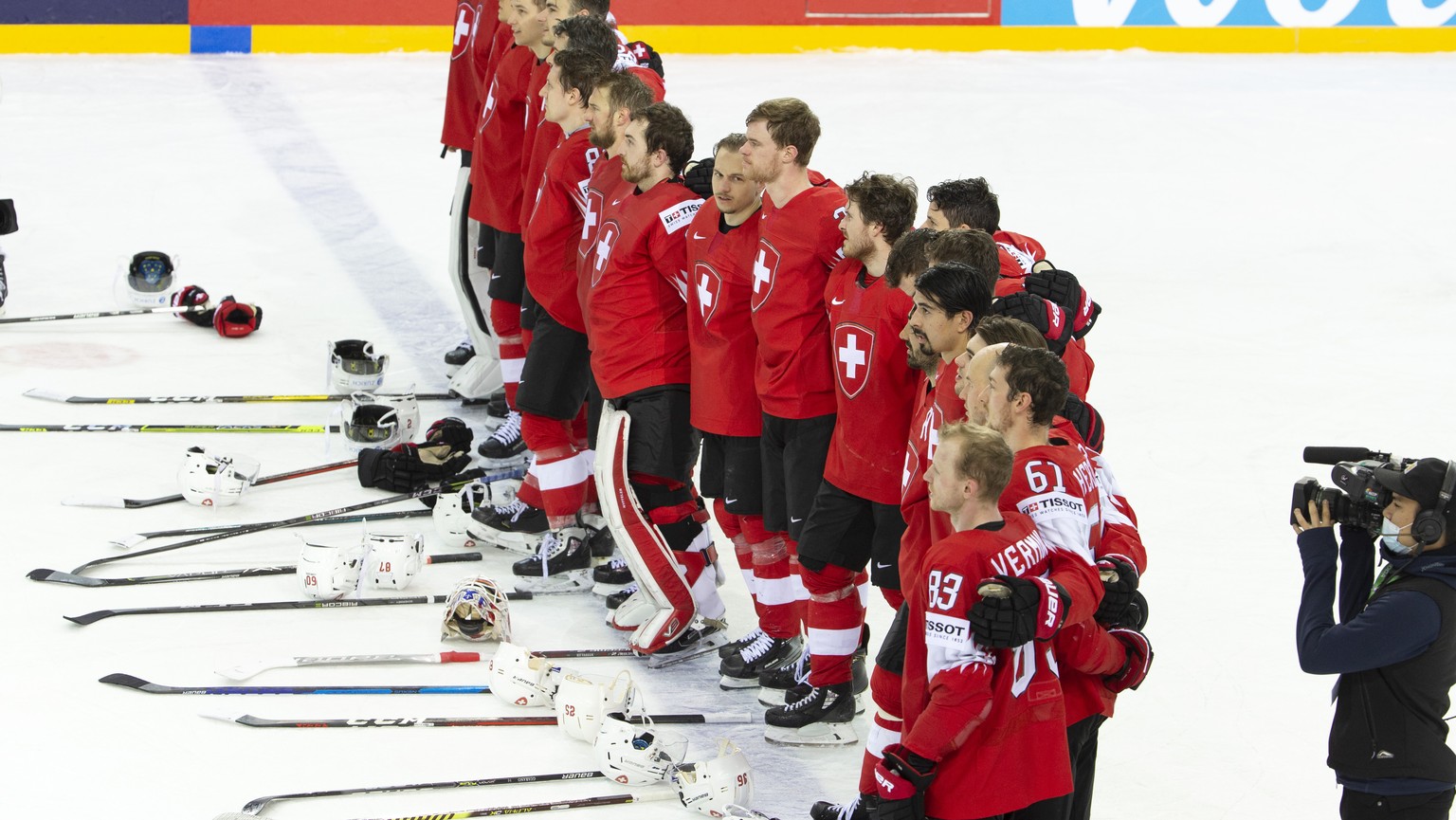 Switzerland&#039;s players listen the Swiss national anthem after winning against the Great Britain team, during the IIHF 2021 World Championship preliminary round game between Switzerland and Great B ...