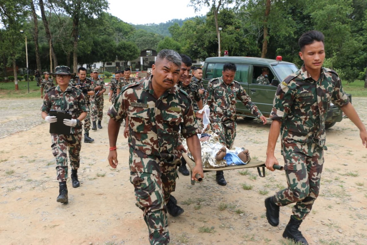 epa13193700 A handout photo made available by the Nepal Army shows army officers conducting a helicopter rescue of survivors following a flash flood in Trishuli Bazar, Nuwakot district, Nepal, 26 Augu ...