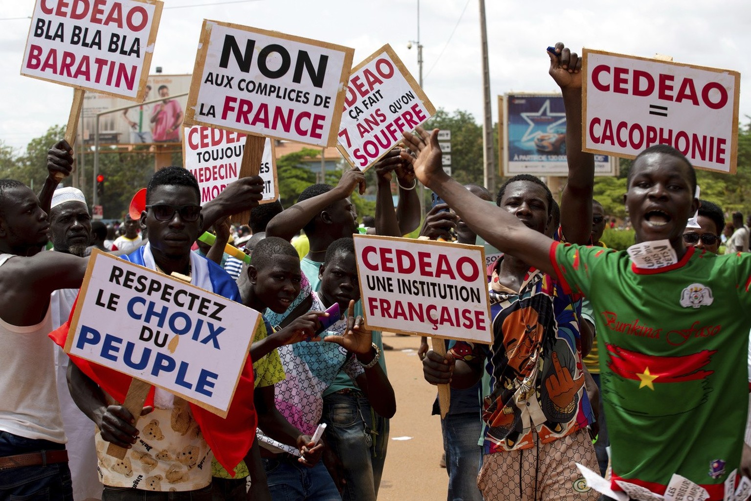 Supporters of Capt. Ibrahim Traore protest against France and the West African regional bloc known as ECOWAS in the streets of Ouagadougou, Burkina Faso, Tuesday, Oct. 4, 2022. A meeting of West Afric ...