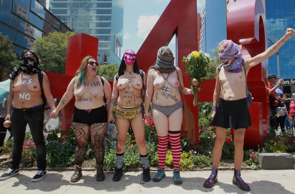 epa06211341 Five half-naked women shout slogans during a march through Mexico City, Mexico, 17 September 2017. Thousands of Mexicans in multiple cities marched against femicides. The demonstrations we ...
